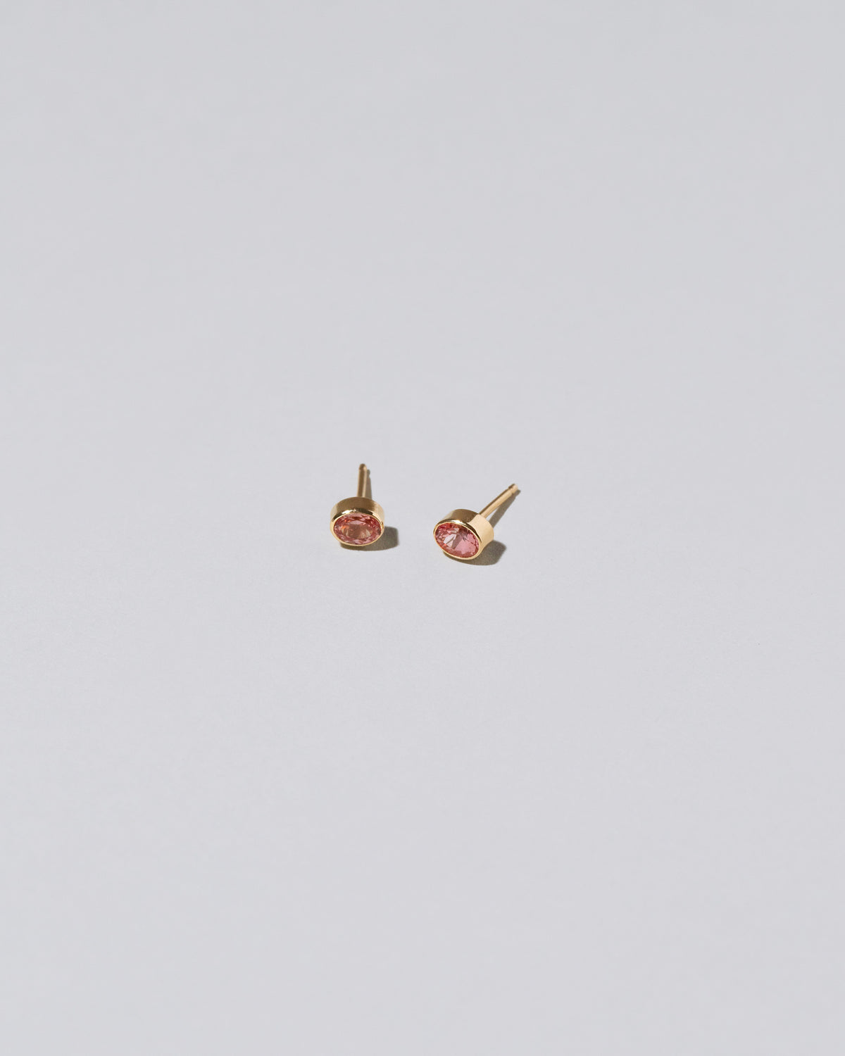 Oval Frame Stud Earrings on light color background.