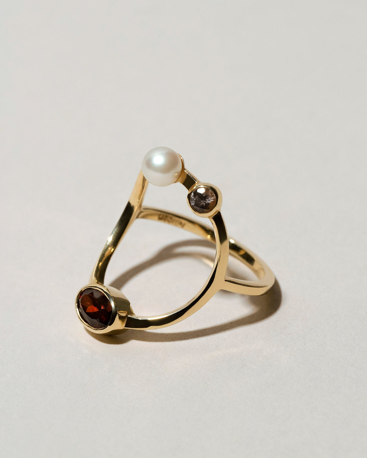  Trilogy Ring - Garnet on light color background.