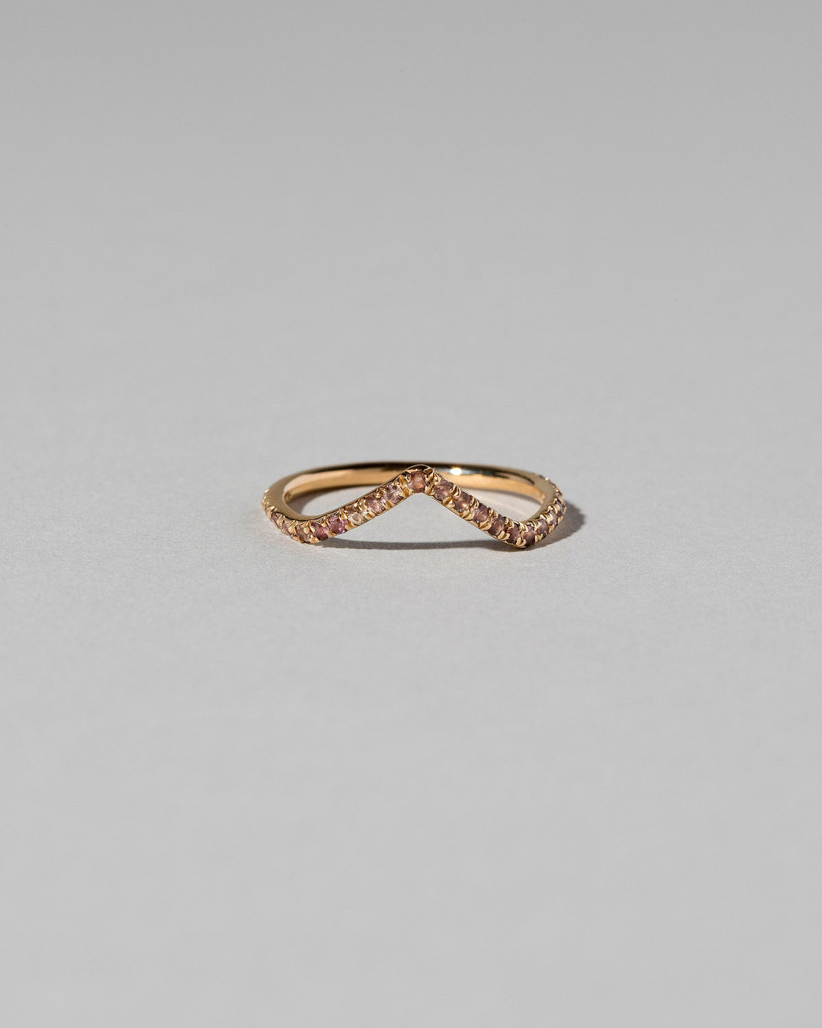 Gold Peach Sapphire Pavé High Peak Band on light color background.