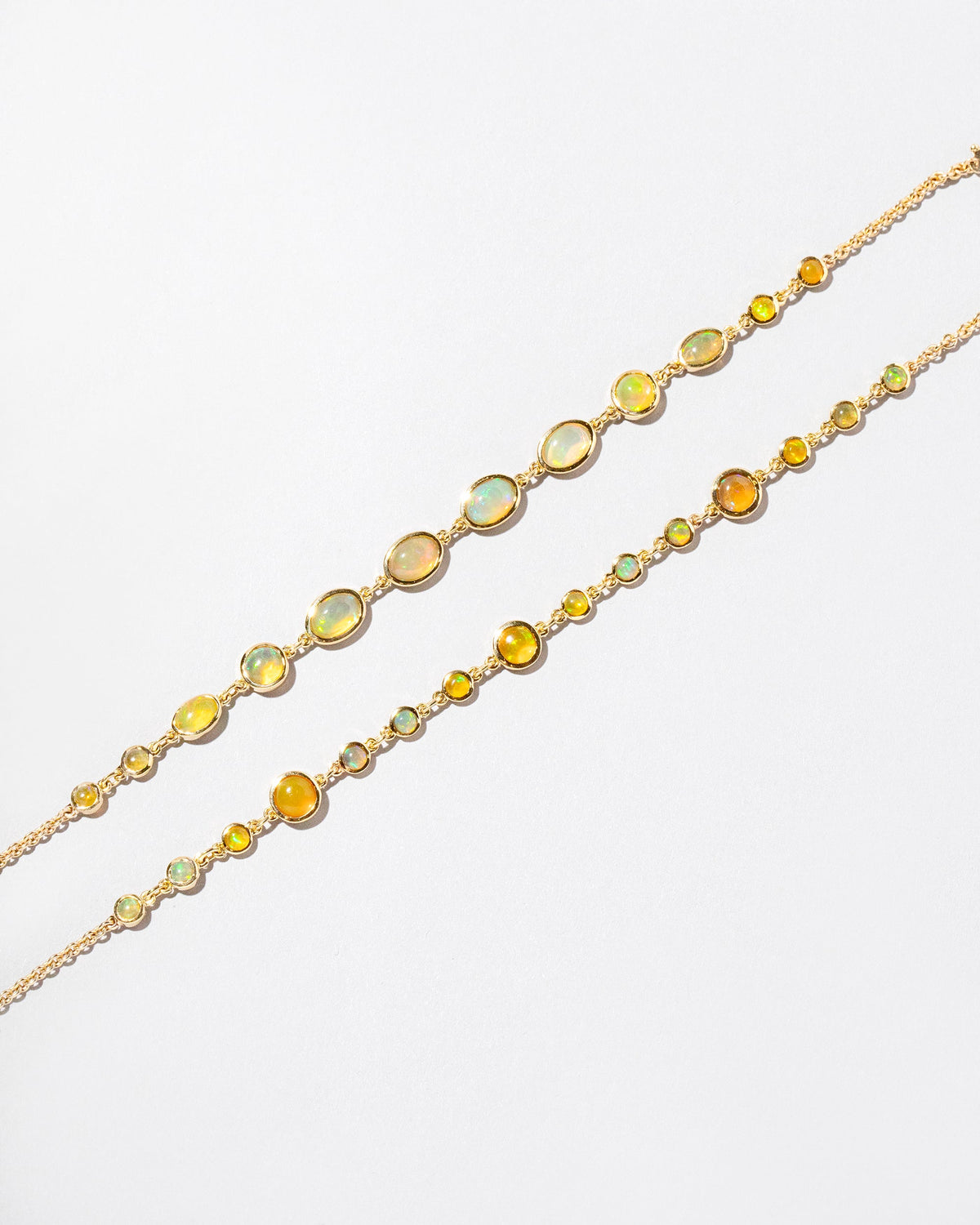  Ops Bracelet and Saturn Bracelet on light color background.