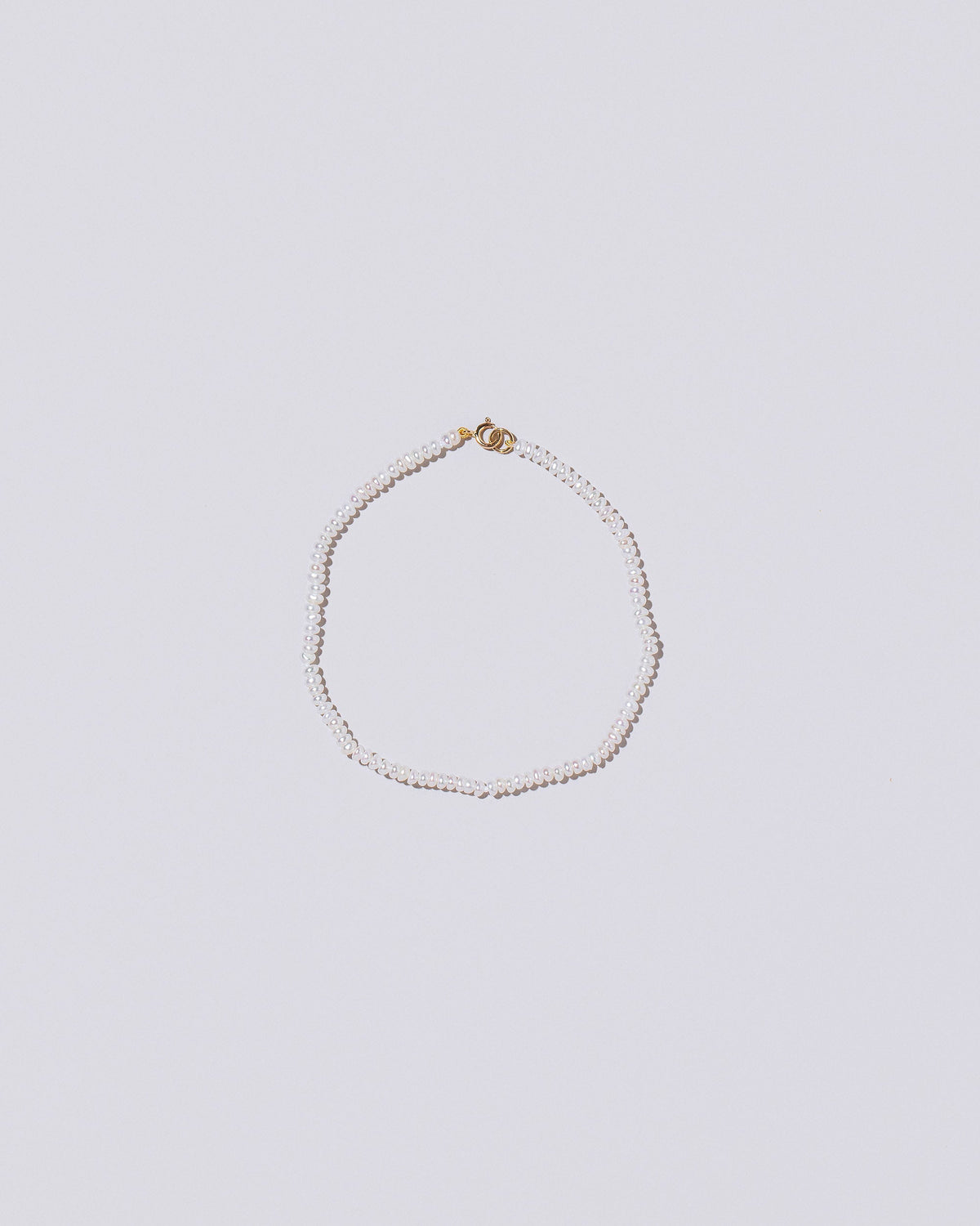 White Seed Pearl Bracelet on light color background.