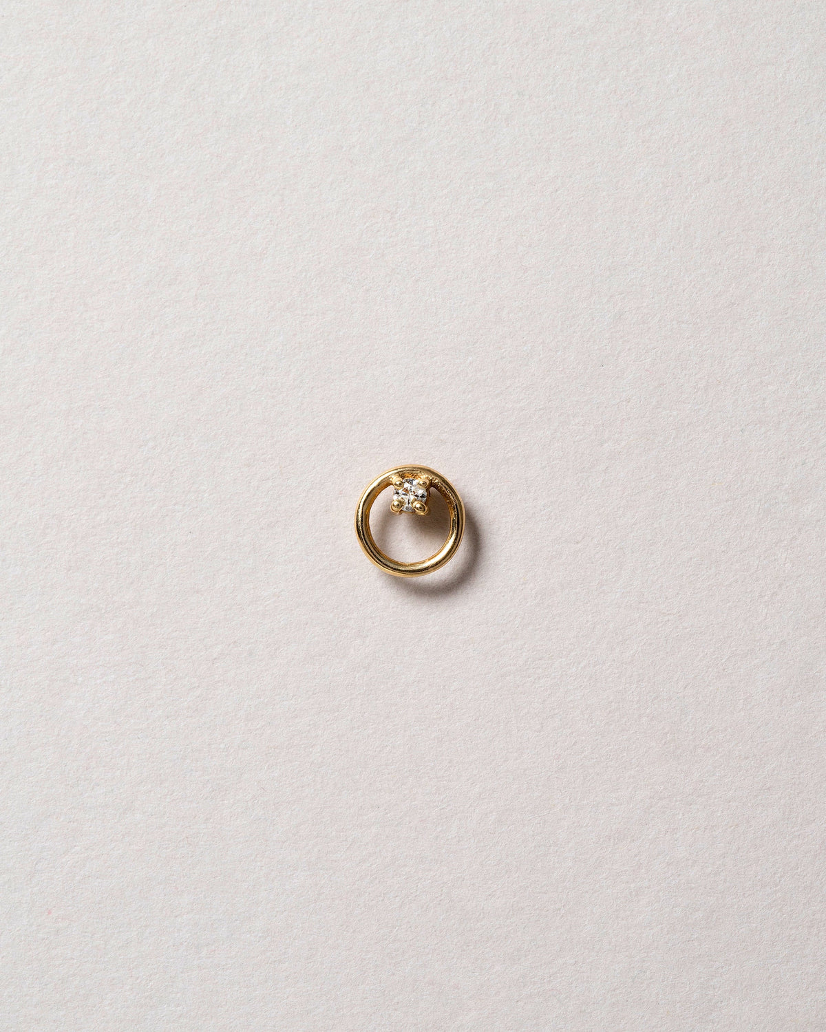 Gold White Diamond Full Moon Stud Earring Single on light color background.
