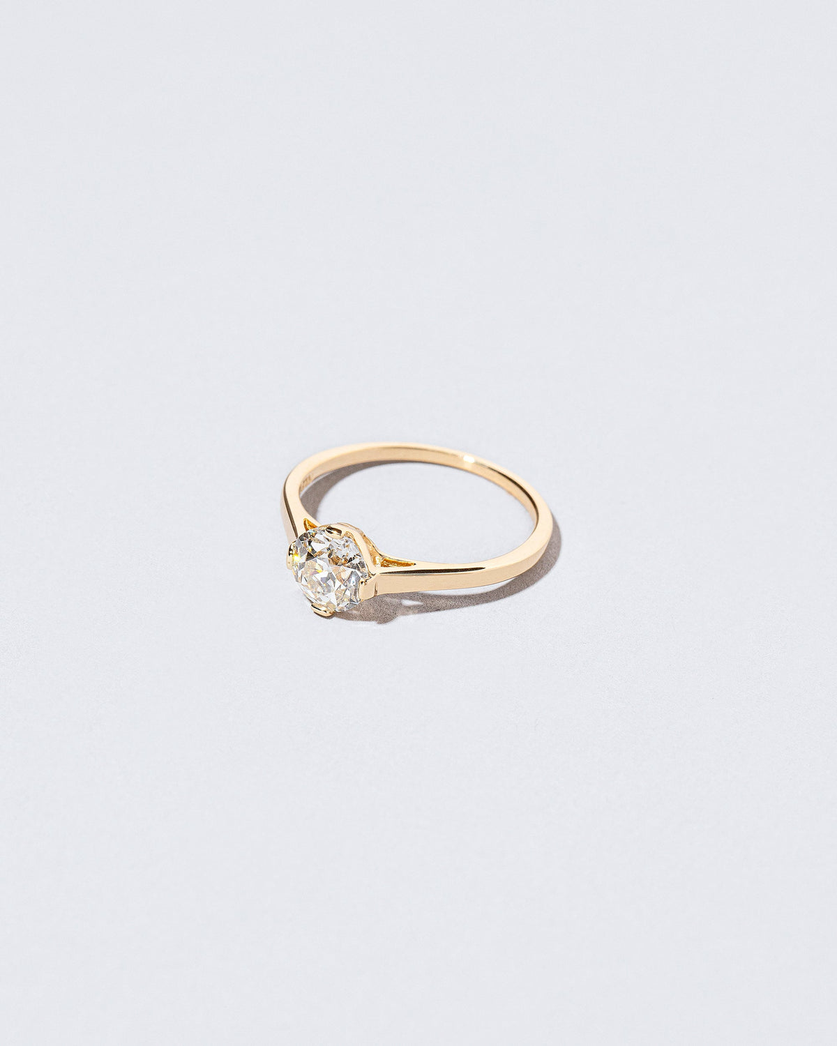 View from the side of the White Diamond Barragán Ring on light color background.