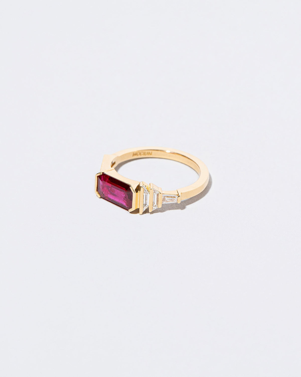 View from the side of the Femme Volage Ring on light color background.