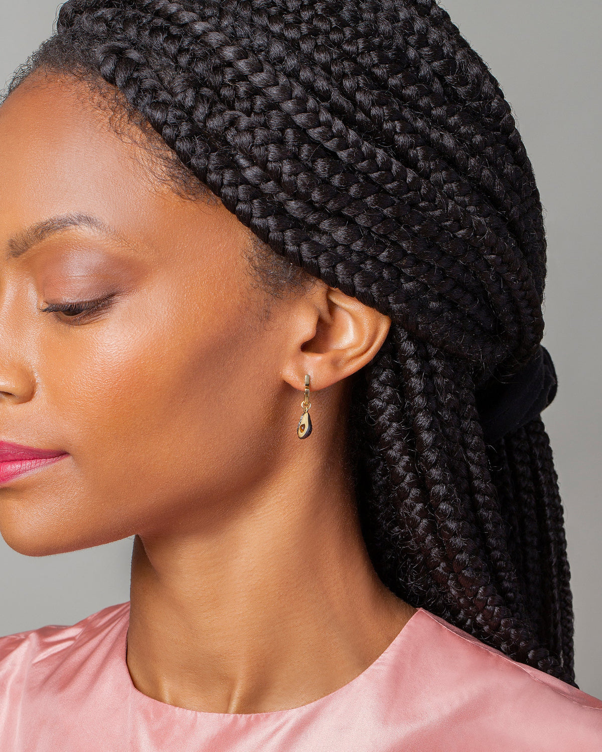 Halved Avocado Charms and Madrone Flower Bud Hoop Earrings on model.