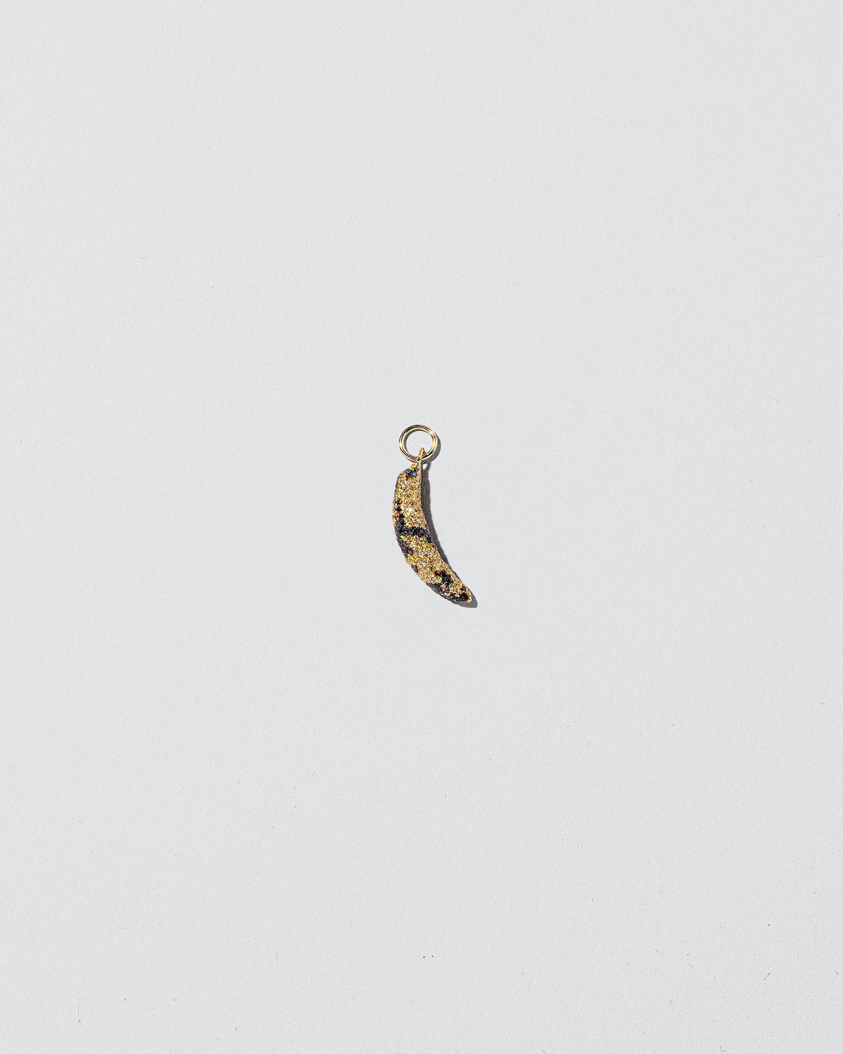 Bruised Banana Charm on light color background.
