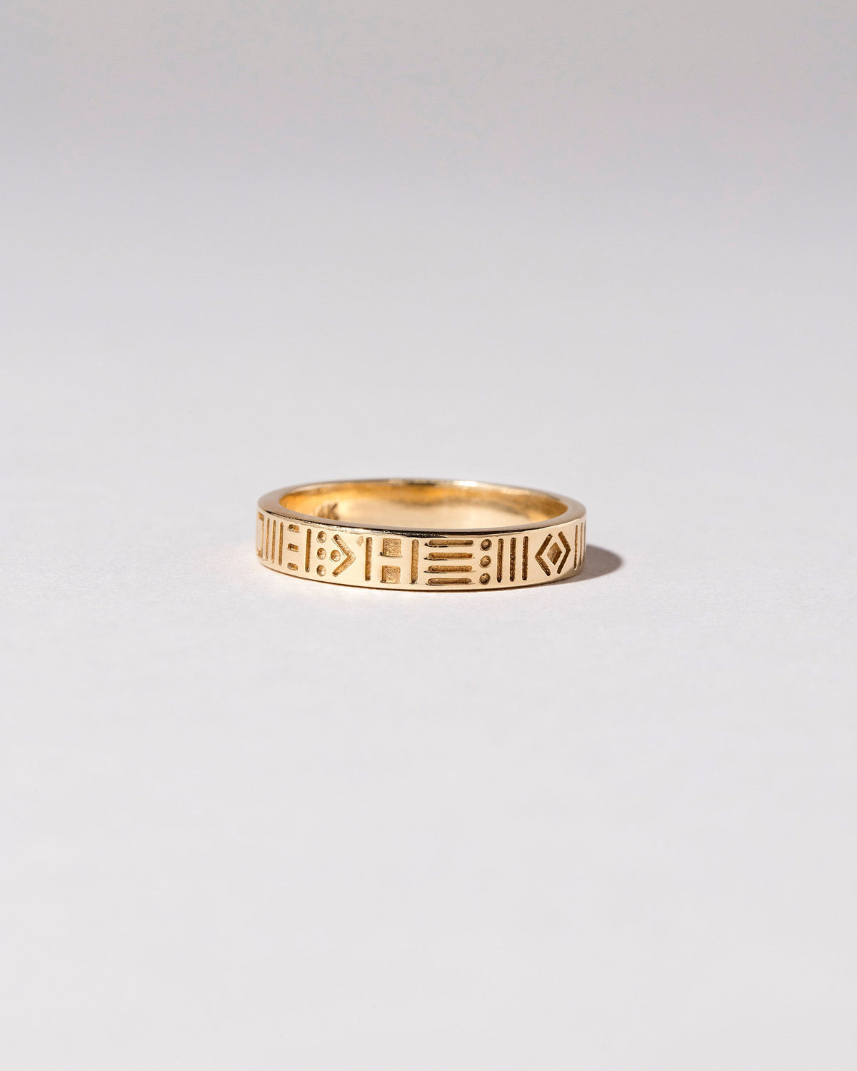 Gold Infinity Etched Band on light color background.