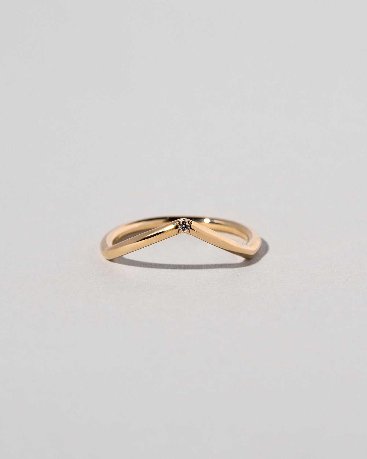 Gold White Diamond Single Stone Luna Peak Band on light color background.