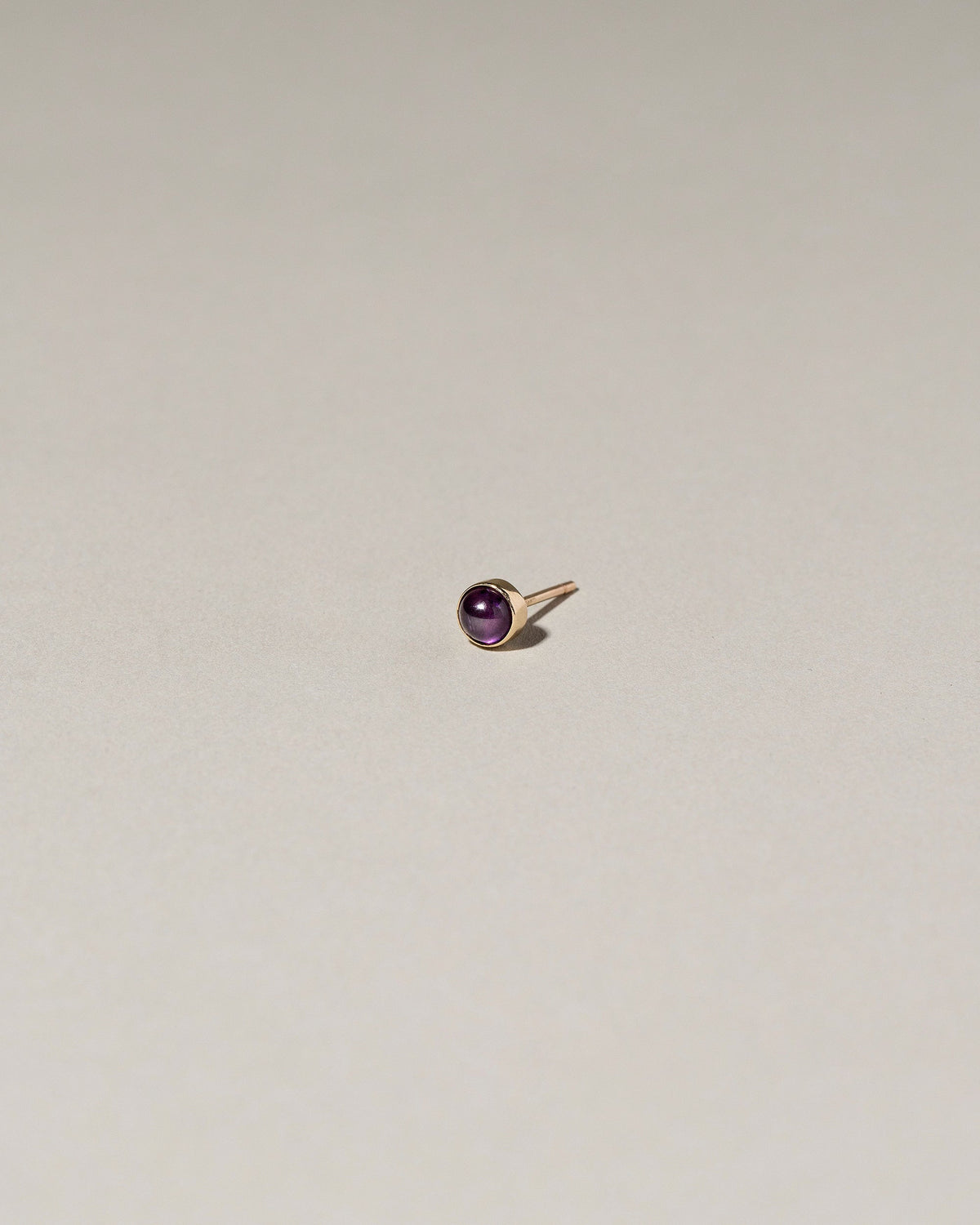  Birthstone Single Stud on light color background.