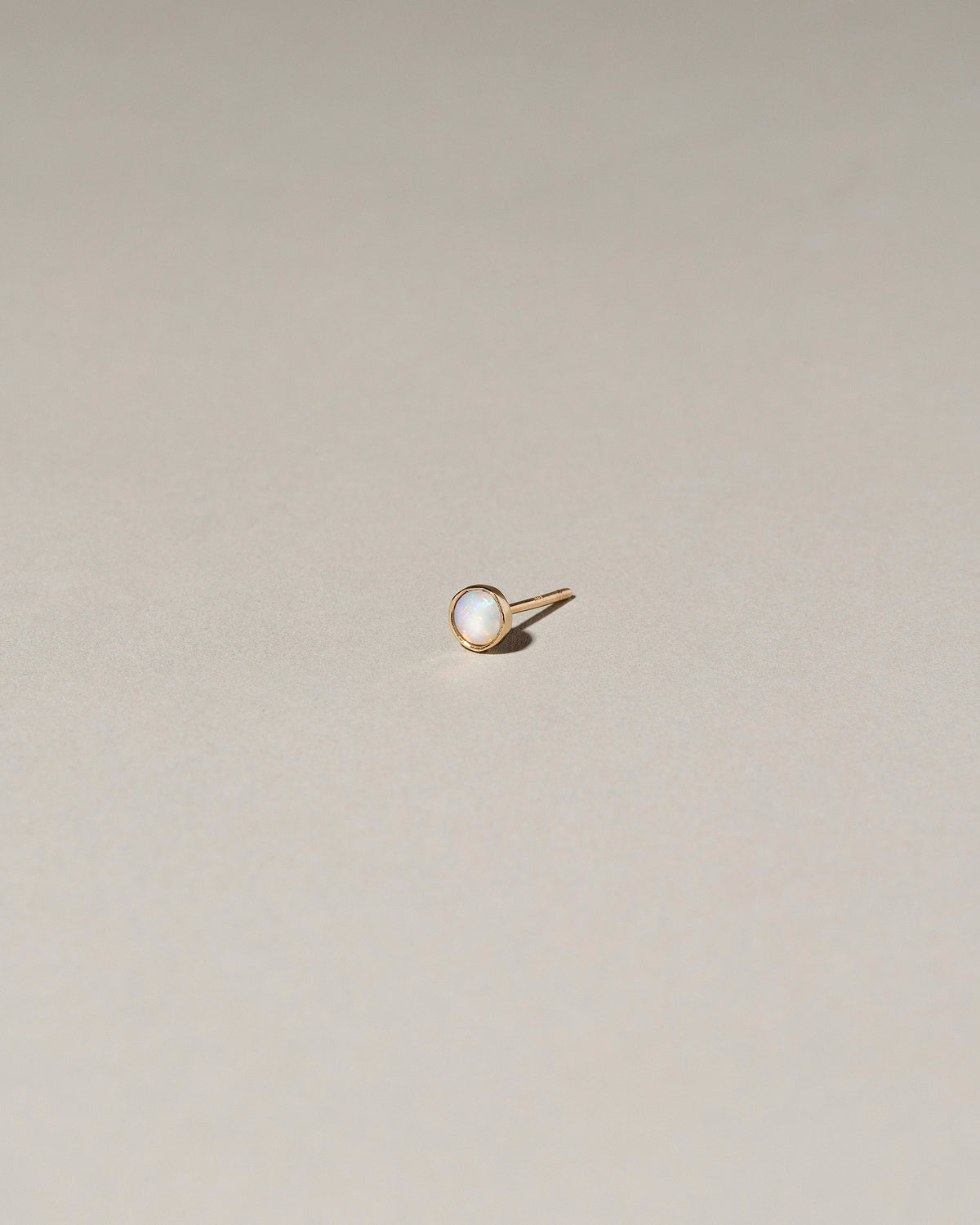 Birthstone Single Stud on light color background.