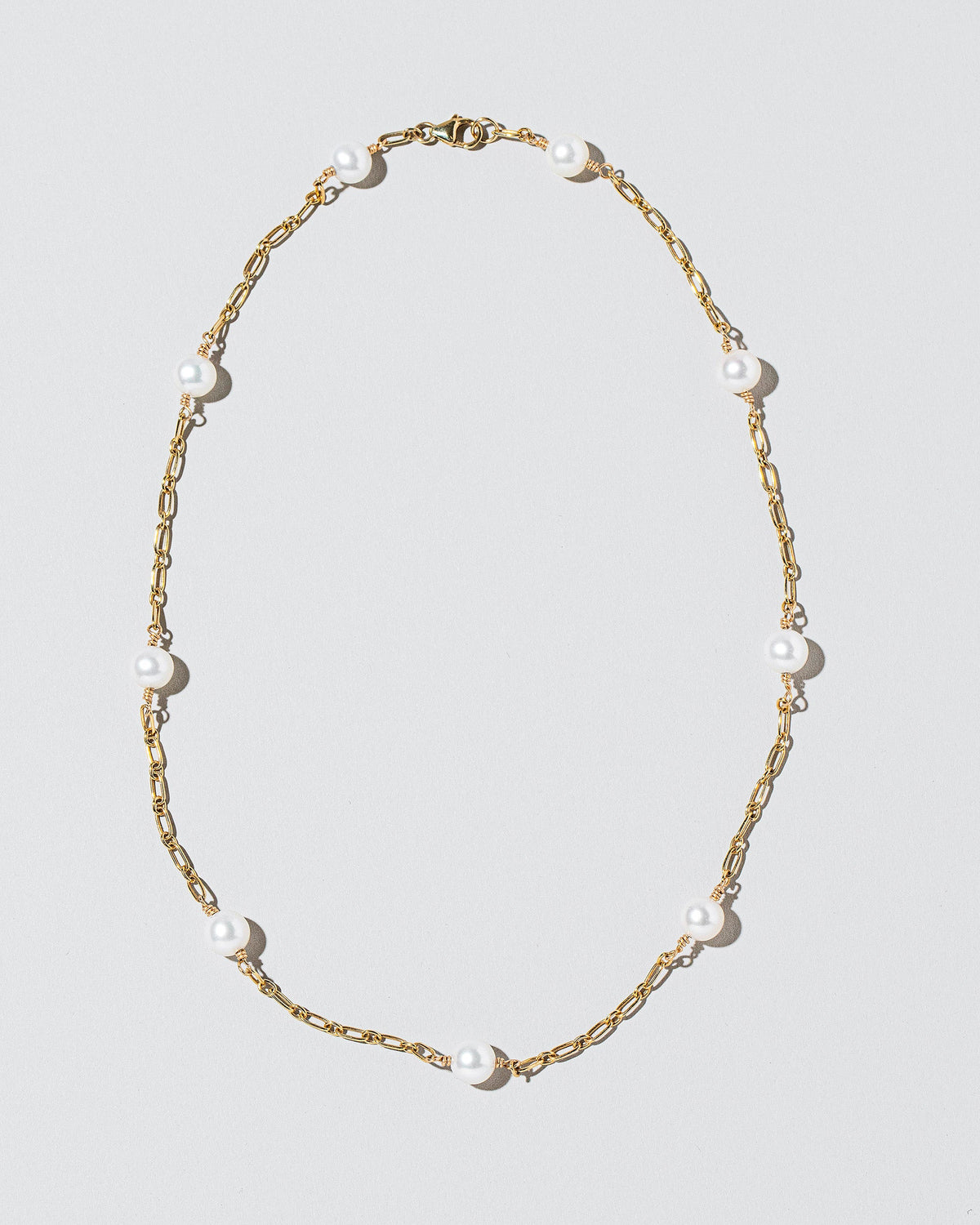  Pearl Station Necklace on light color background.