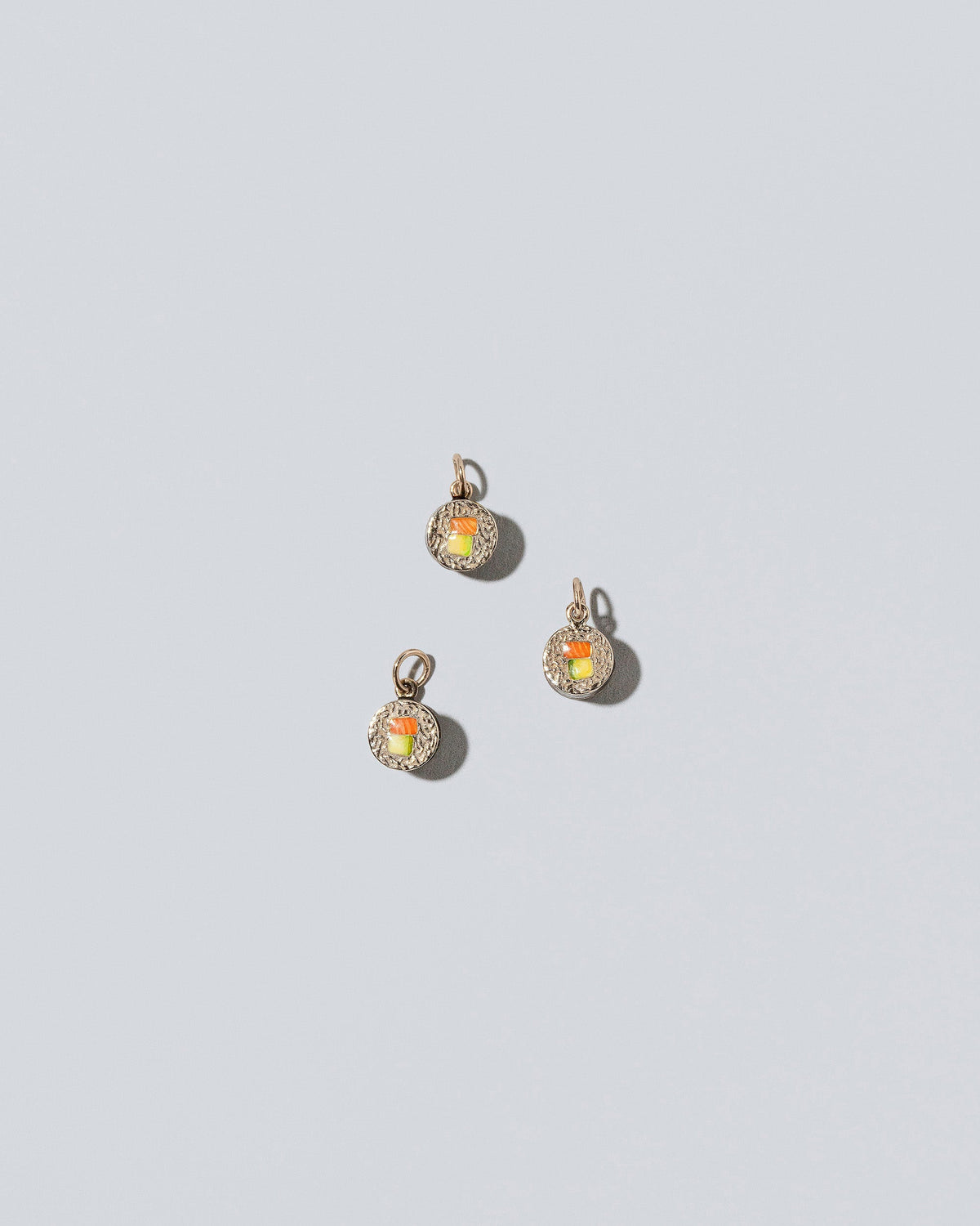 Sushi Charms on light color background.