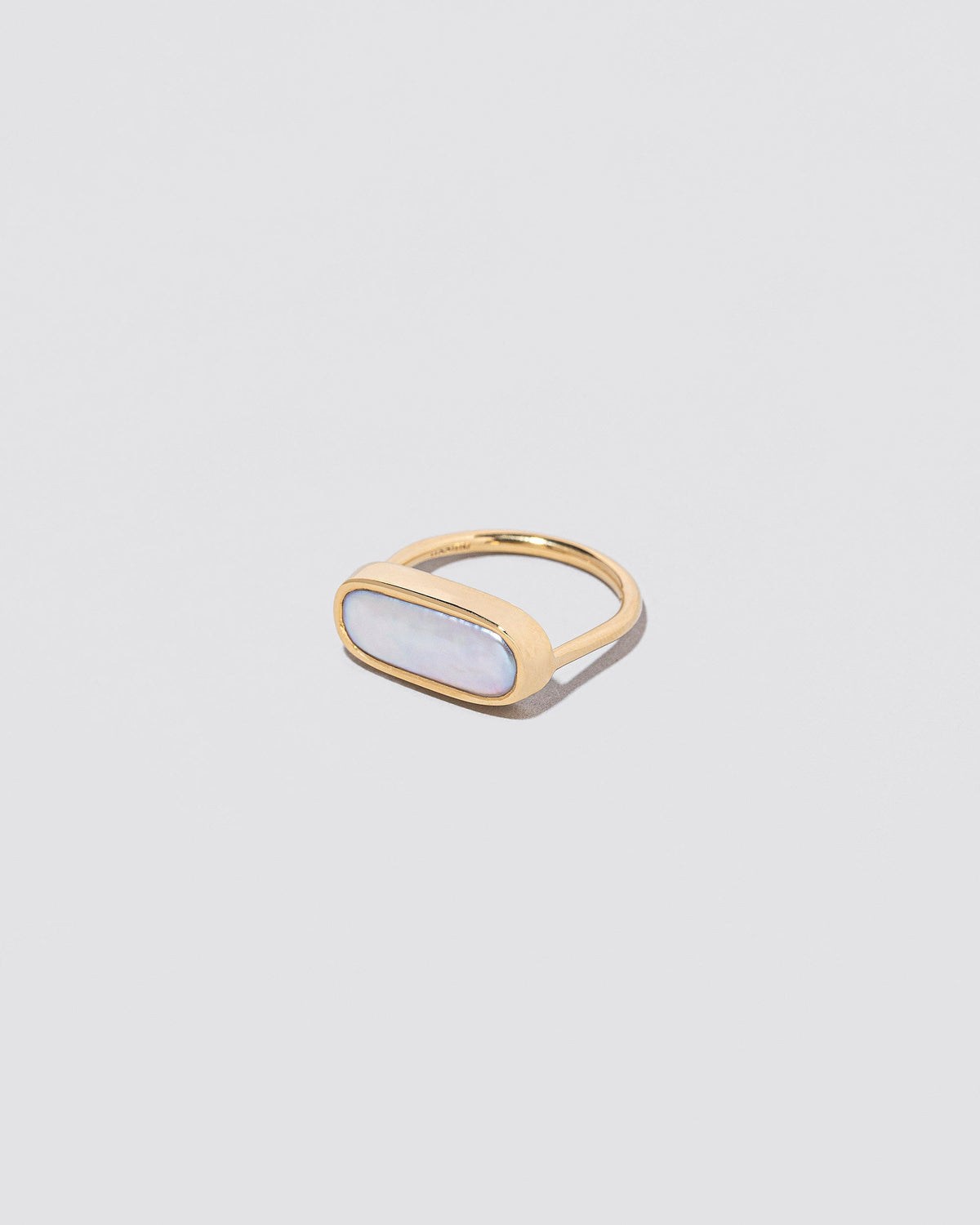 View from the side of the Antaeus Ring on light color background.