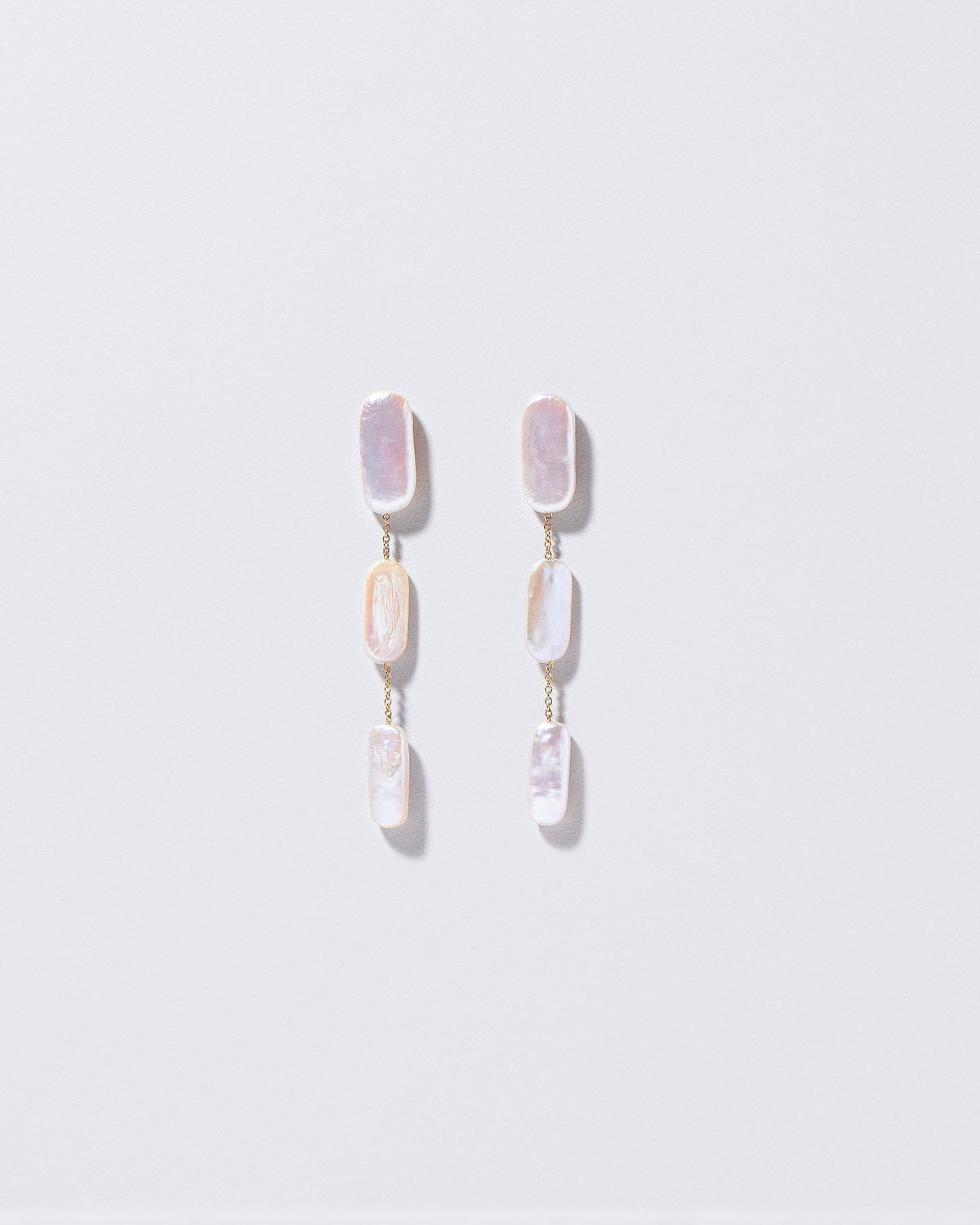  Pelias Earrings on light color background.