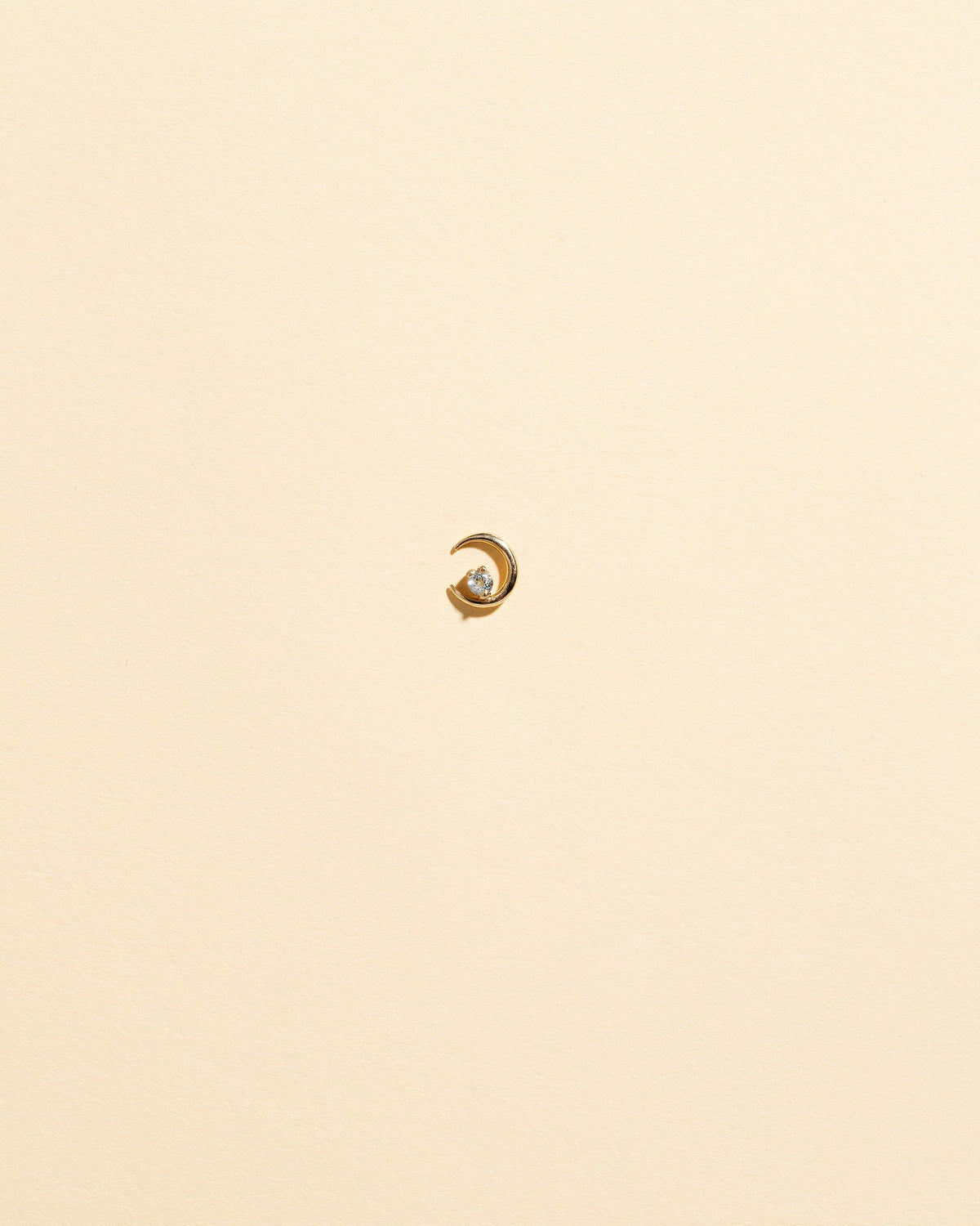 Left White Diamond Moon Ray Stud Earring Single on light color background.