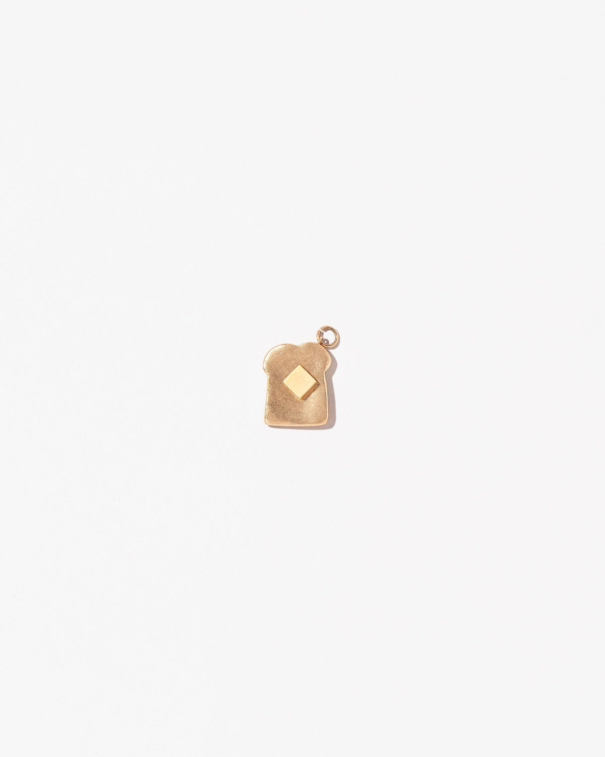 Buttered Toast Charm on light color background.