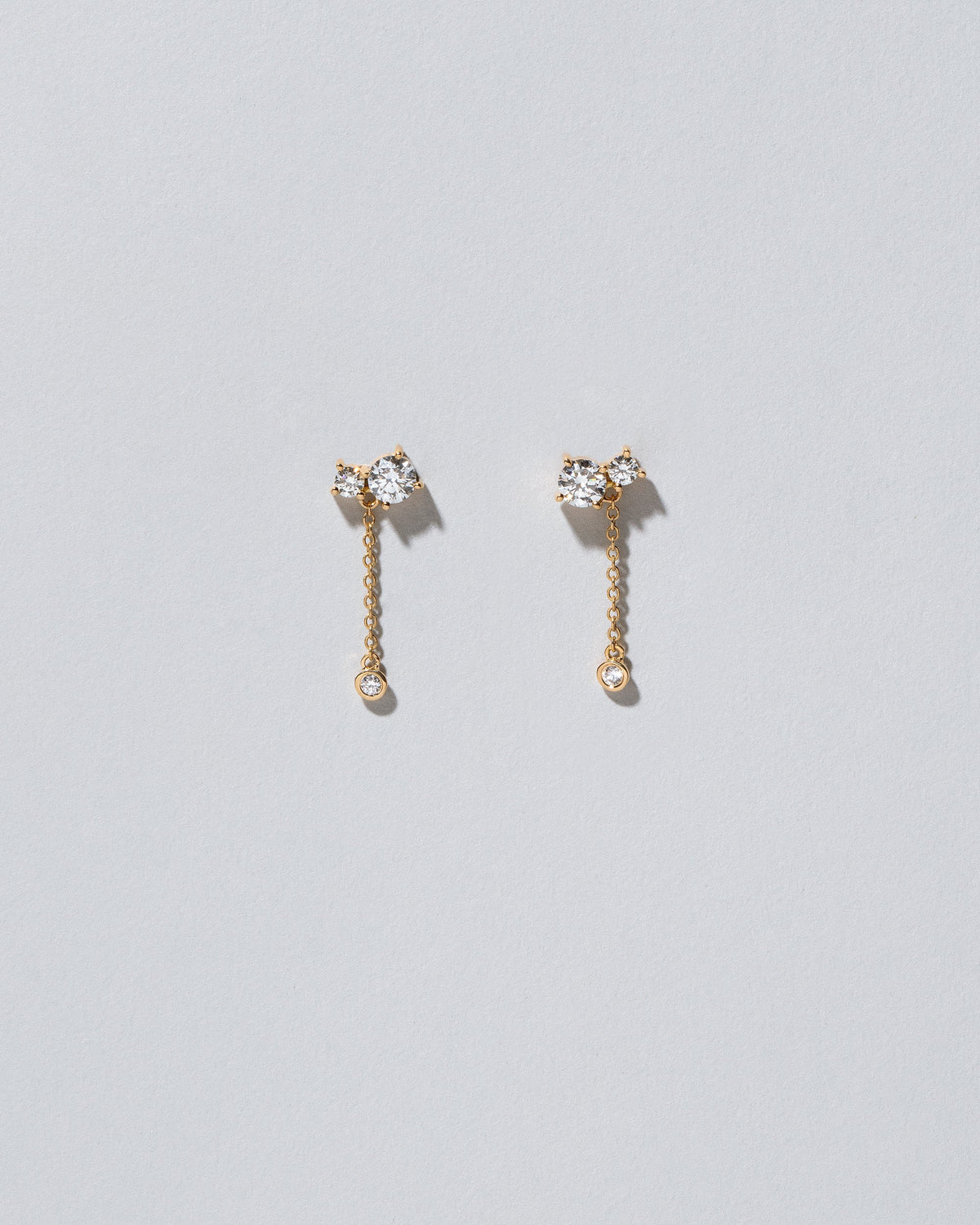 Drop Aster Earrings on light color background.