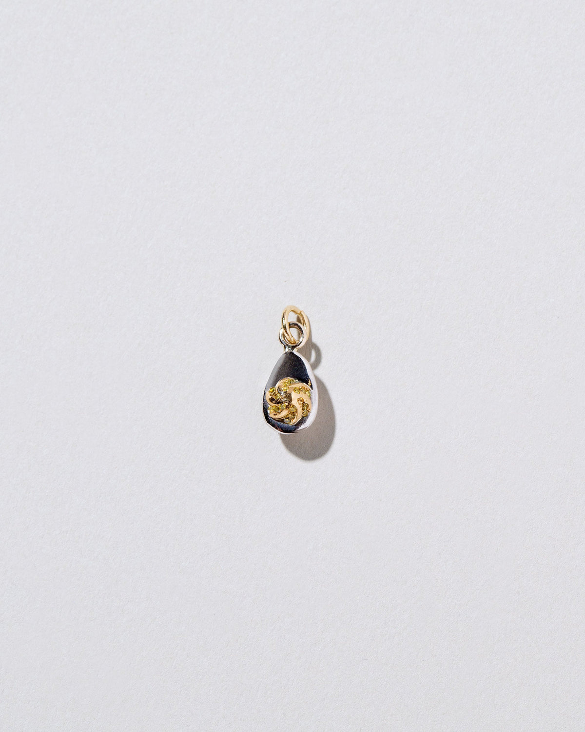 Deviled Egg Charm on light color background.