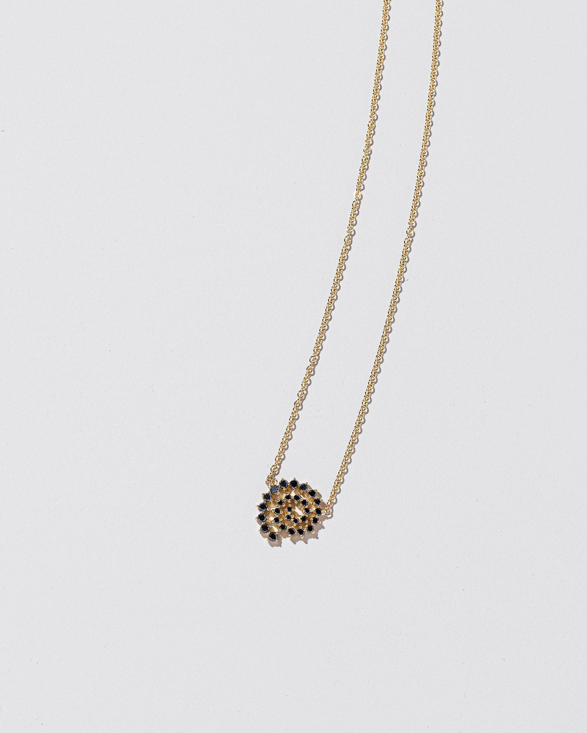 Full Black Diamond Spiral Necklace on light color background.