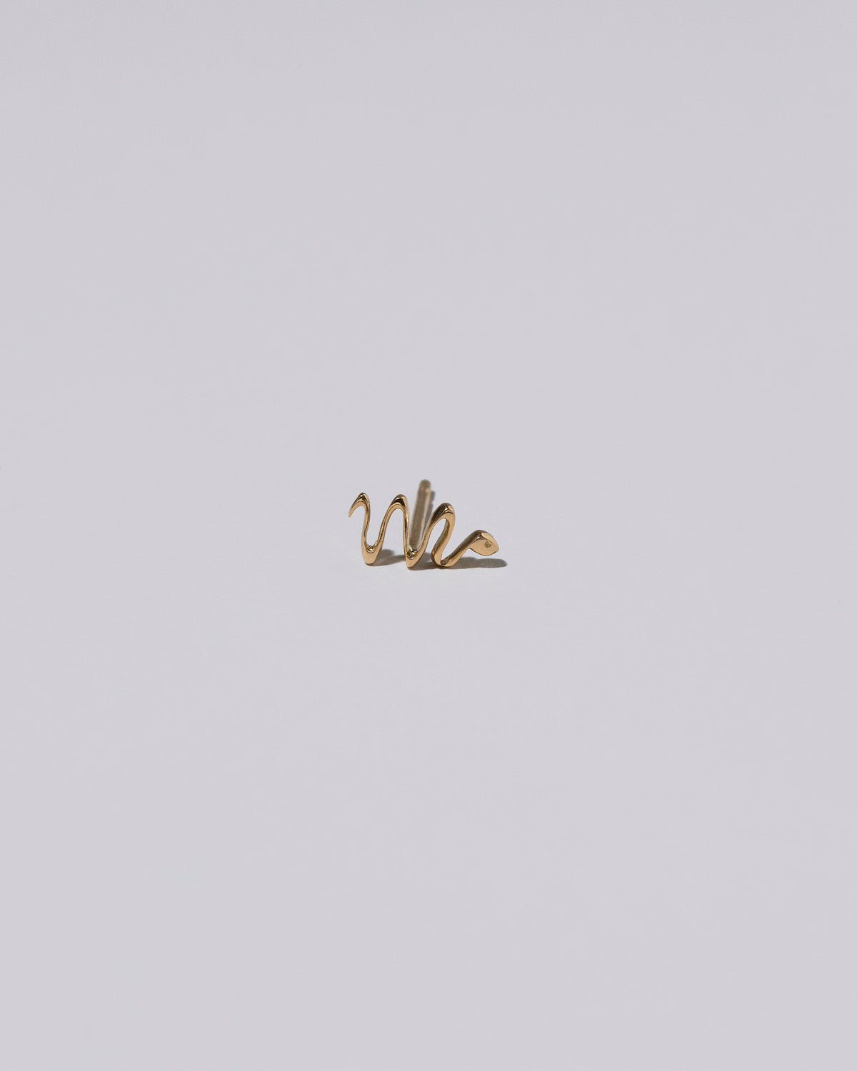 Right Snake Stud Earring Single on light color background.