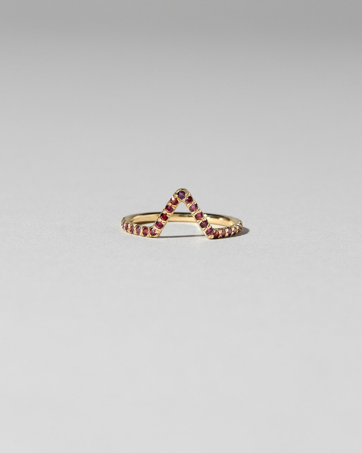 Red Anthill Garnet Pavé Triangle Band on light color background.