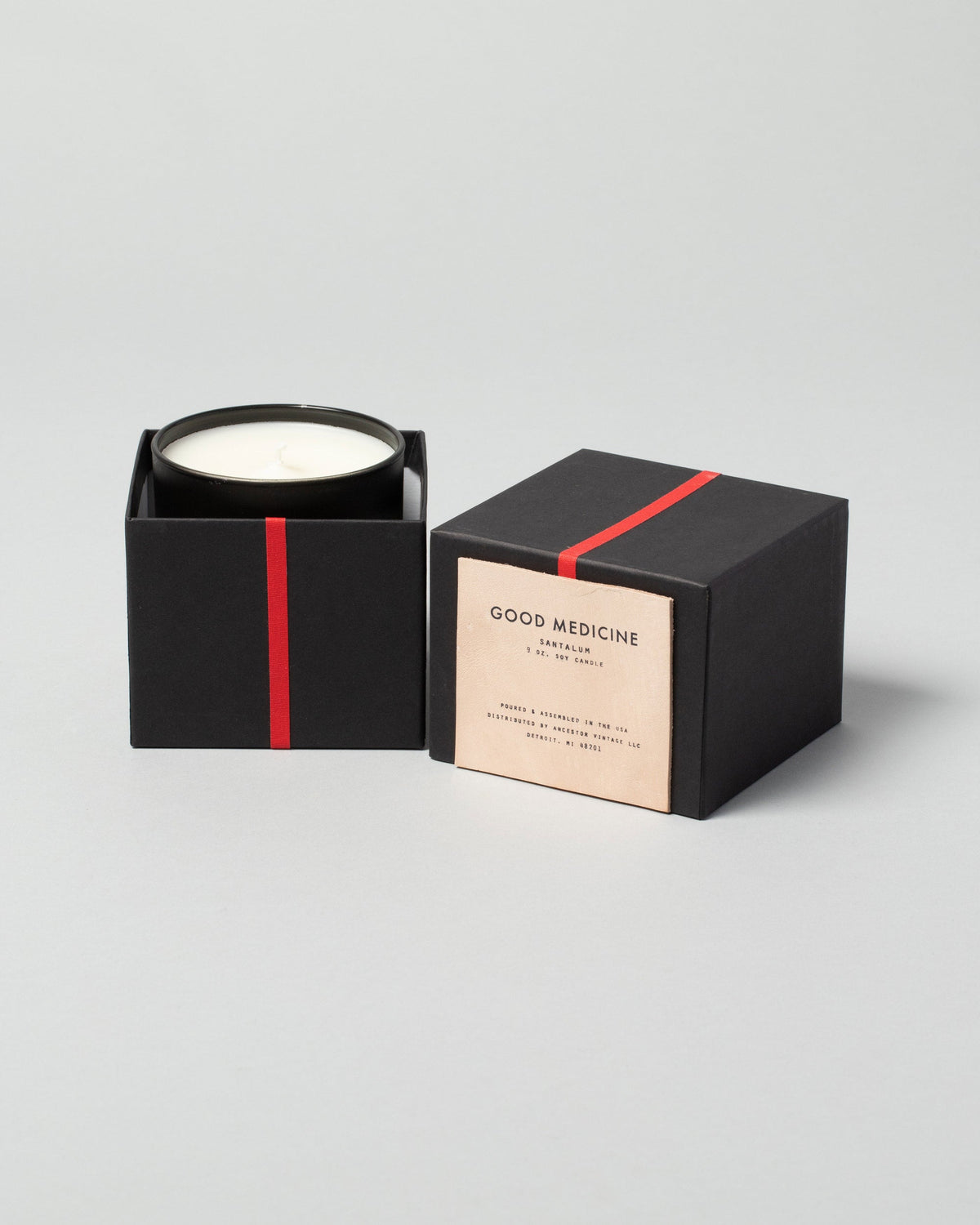 Good Medicine Santalum Candle on light color background.