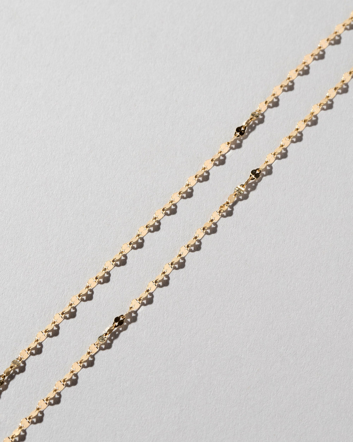  Streamer Chain Necklace on light color background.