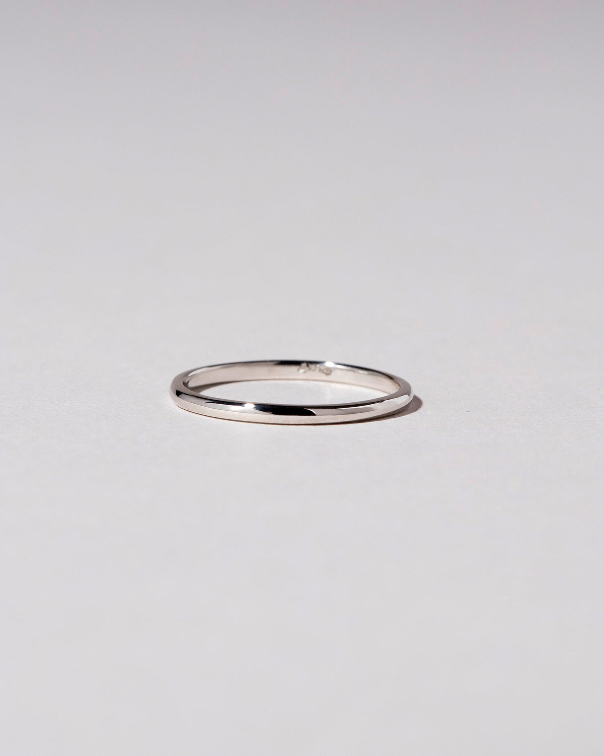 Platinum 1mm Half Round Band on light color background.