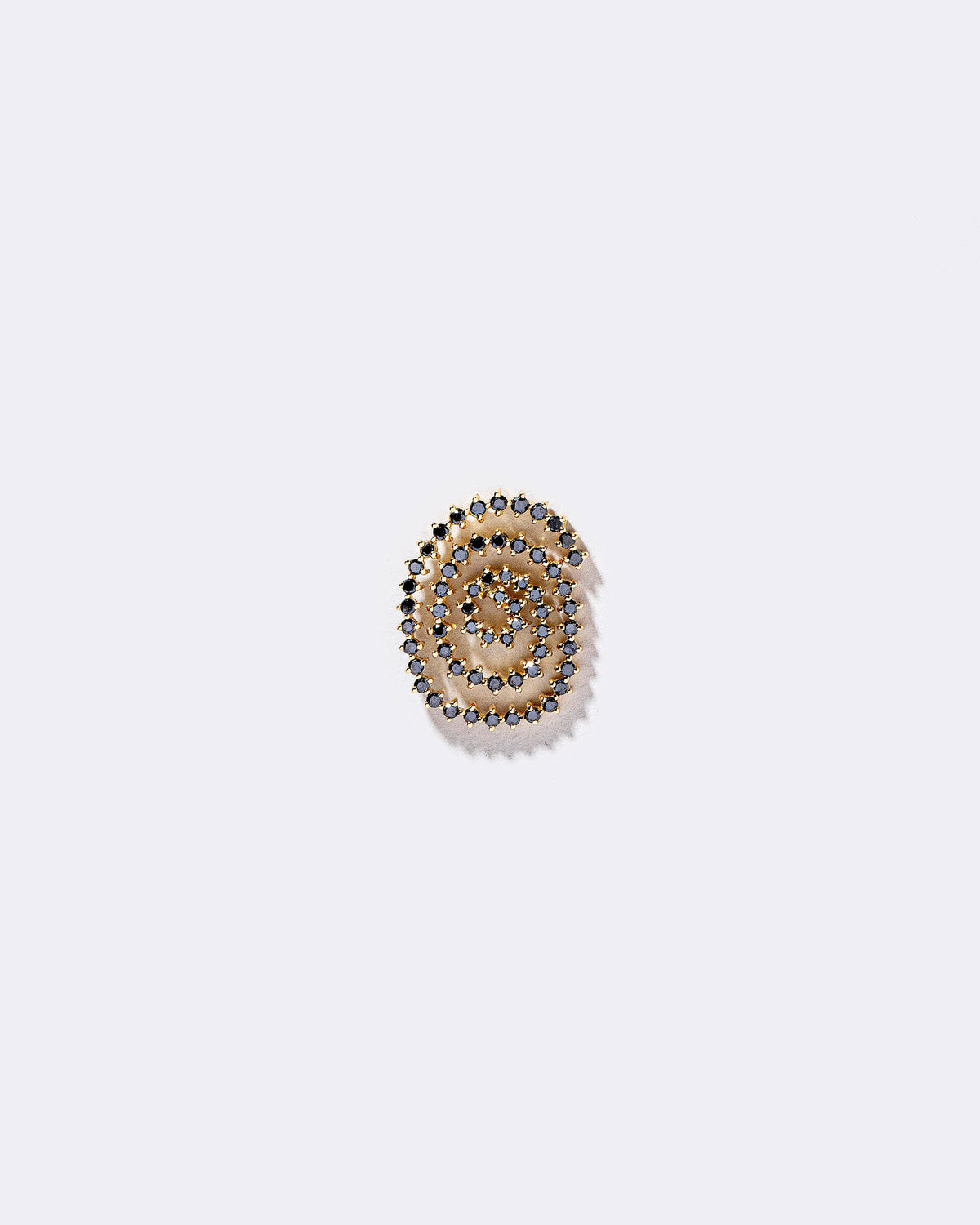 Right Black Diamond Cycle of Rebirth Earring Single on light color background.