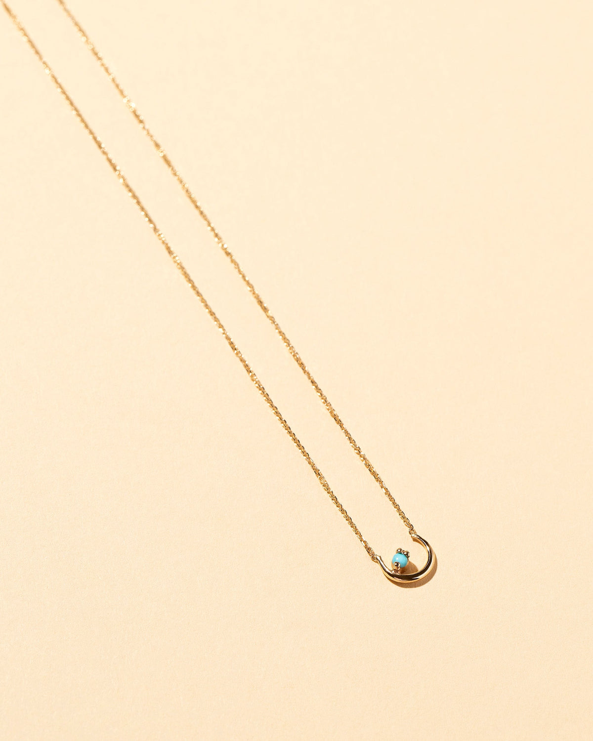  Moon Ray Necklace on light color background.