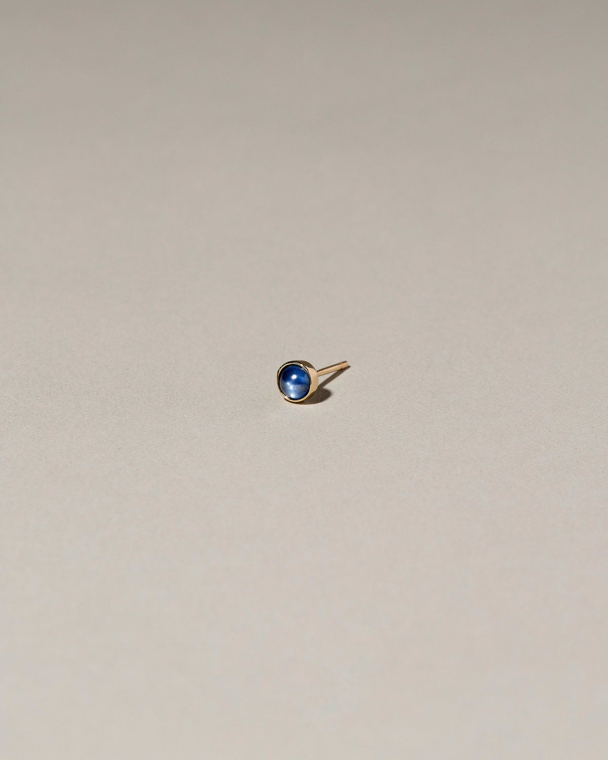  Birthstone Single Stud on light color background.