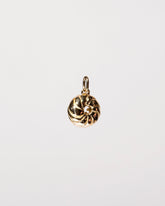 View from the side of the  French Cruller Charm on light color background.