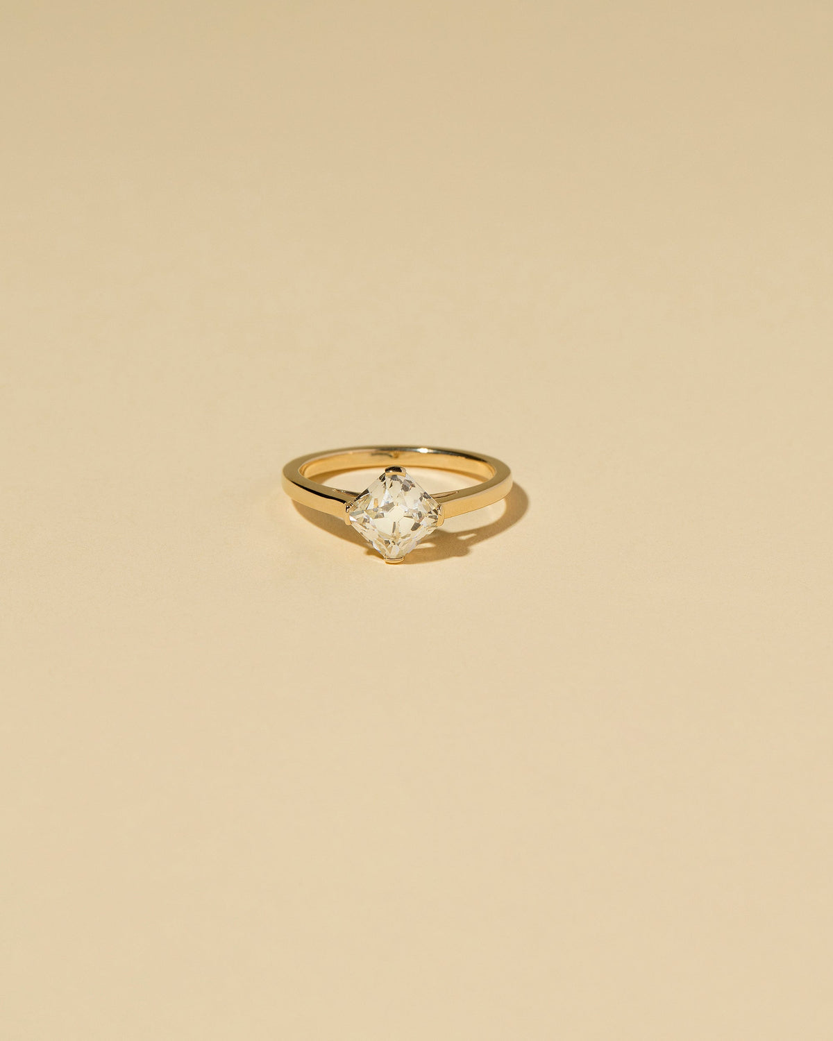 Cushion Modified Brilliant Diamond Solitaire Ring on light color background.
