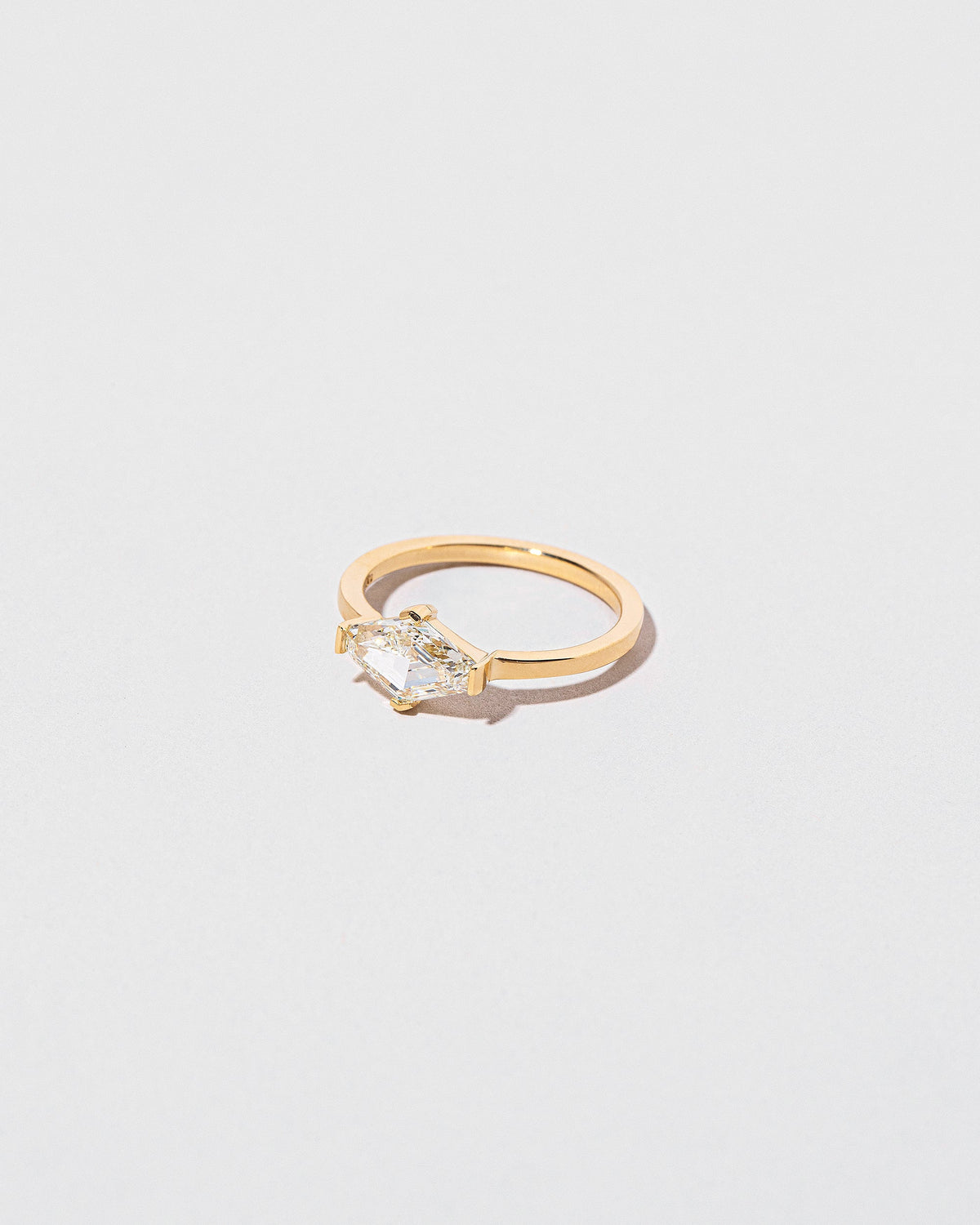 View from the side of the Divine Geometry Ring on light color background.