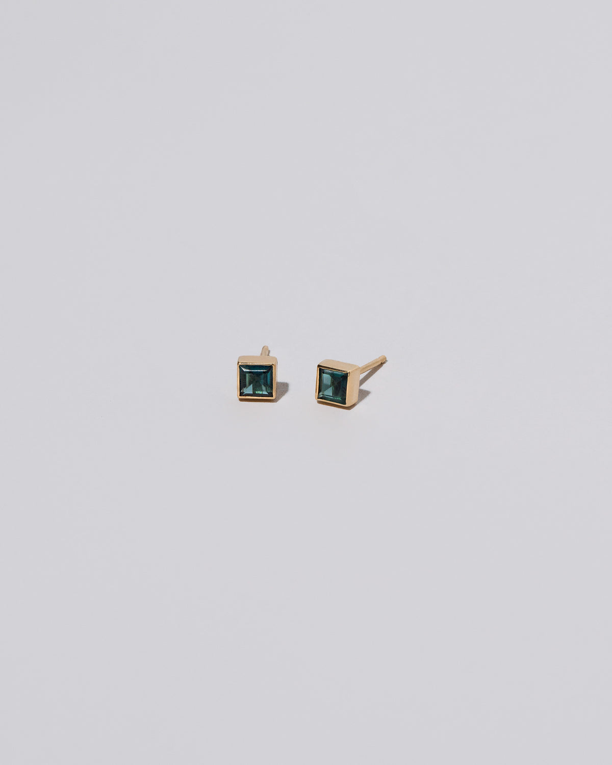 Square Stud - Teal Tourmaline on light color background.