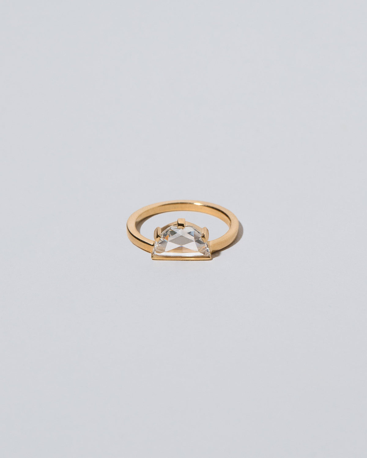 Plié Ring on light color background.