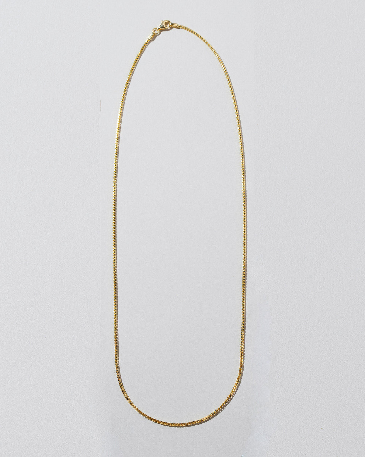 1mm Ritual Chain Necklace on light color background.