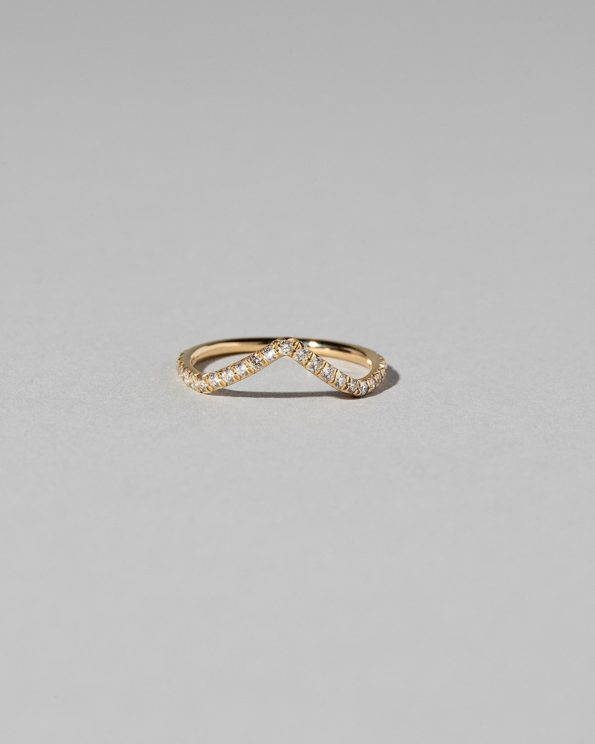 Gold White Diamond Pavé High Peak Band on light color background.