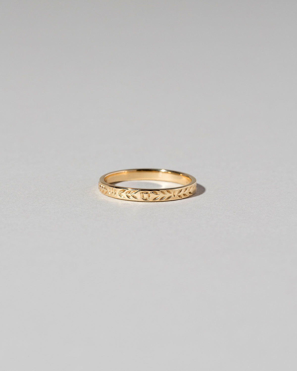 Gold Etched Infinity Pattern Band on light color background.
