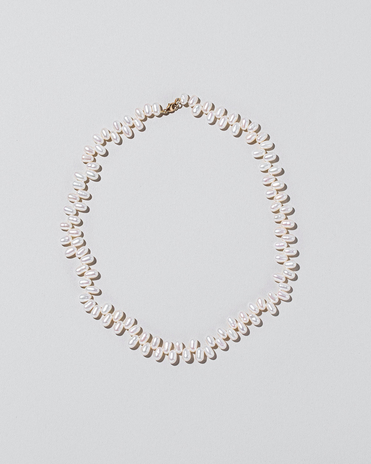 Large Zipper Pearl Necklace on light color background.