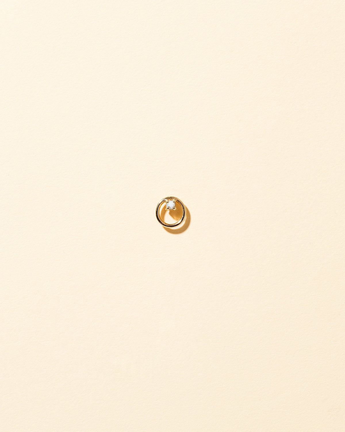 Gold Opal Full Moon Stud Earring Single on light color background.