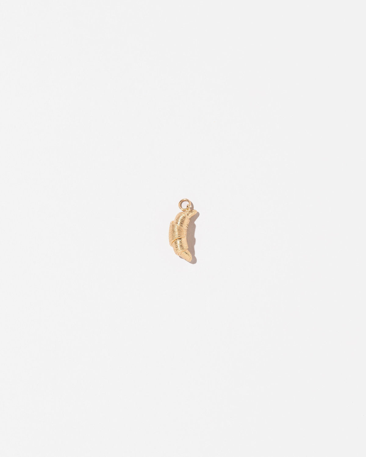 Croissant Charm on light color background.