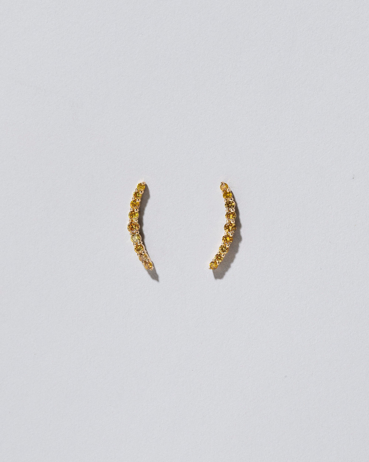 Crescent Ear Climber Stud Earrings - Yellow Diamond on light color background.