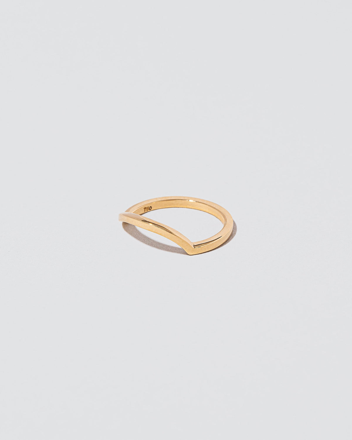 View from the side of the Gold Solid Square Wire Right Slump Band on light color background.
