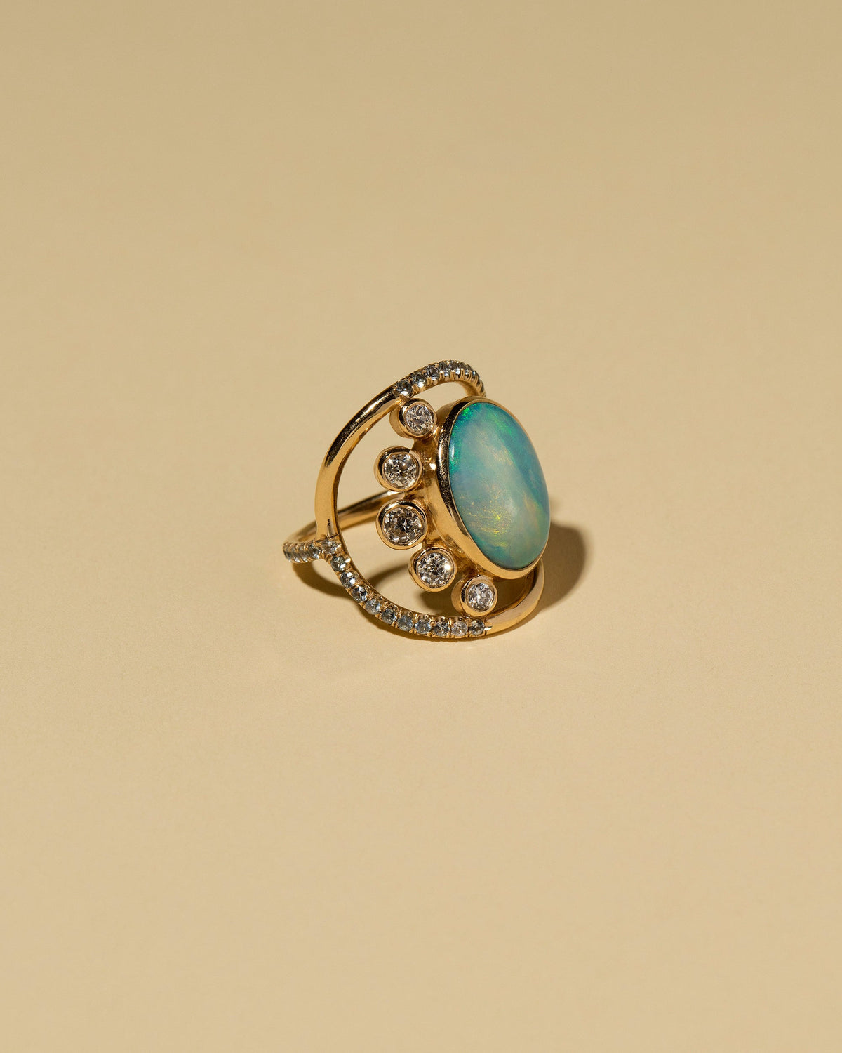 Australian Opal, Diamond & Sapphire Ring on light color background.