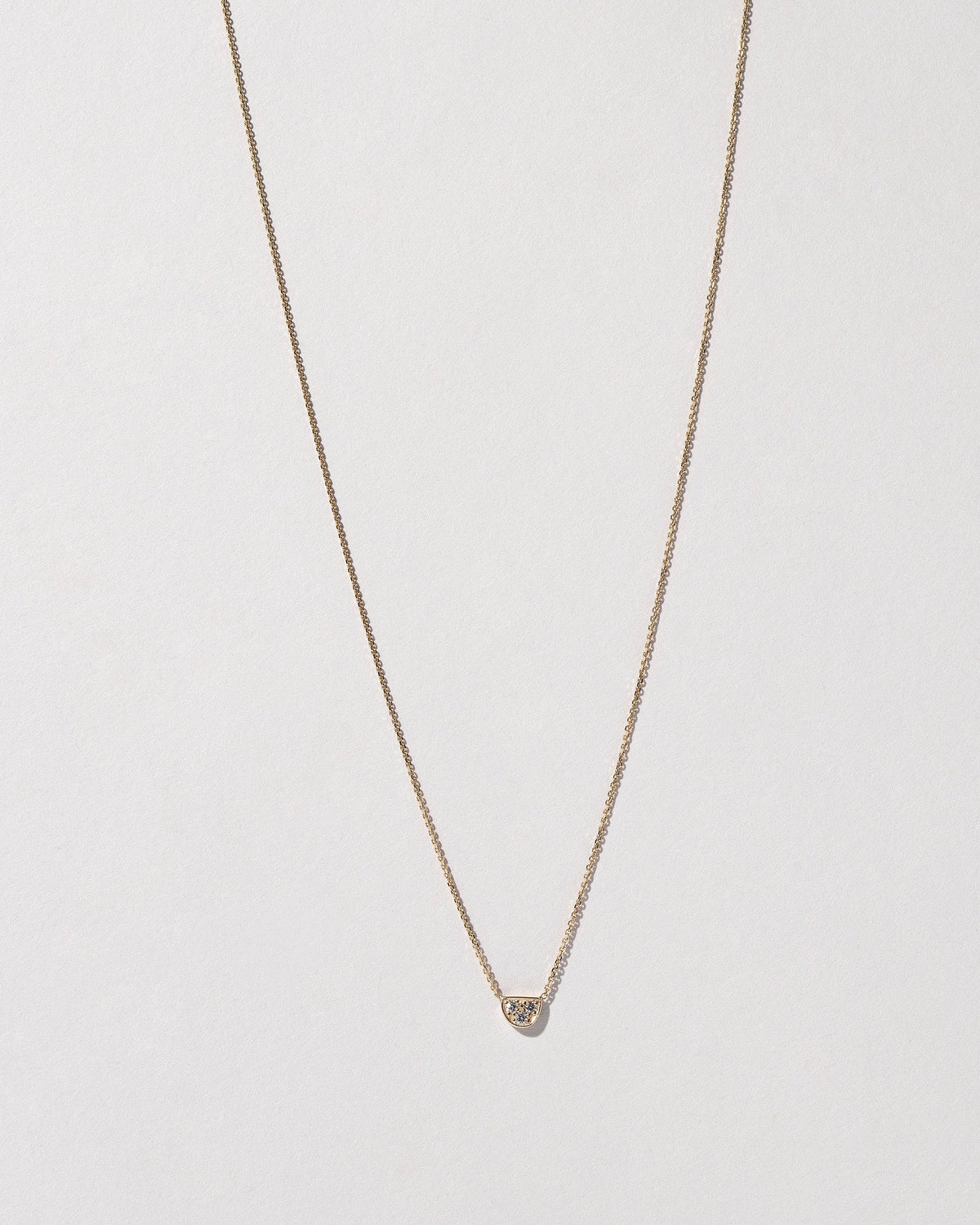  Half Moon Necklace on light color background.