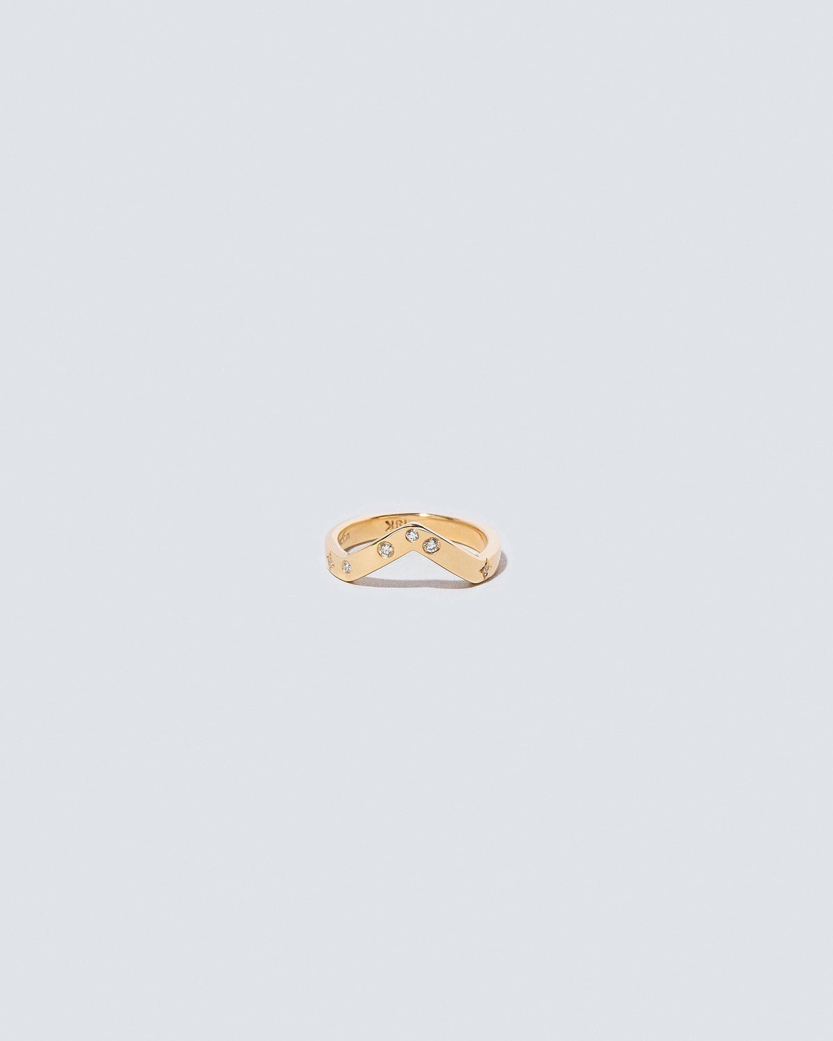 Gold Wide High Peak Band with white diamond little array added on light color background.