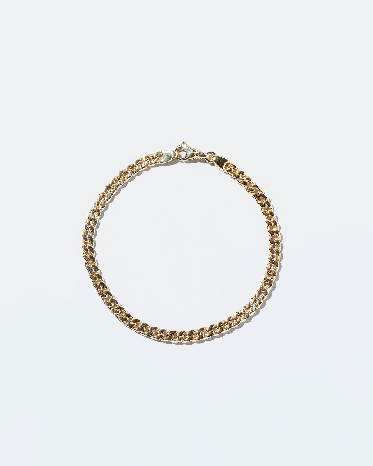 Group of 4.7mm Curb Chain Bracelets on lightcolor background.