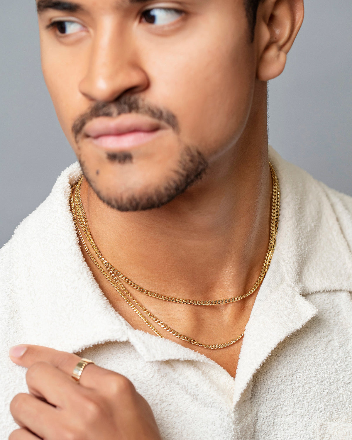 Gold Etched Lines Band with 3.4mm Curb Chain Necklace and 2.4mm Curb Chain Necklace on male model.
