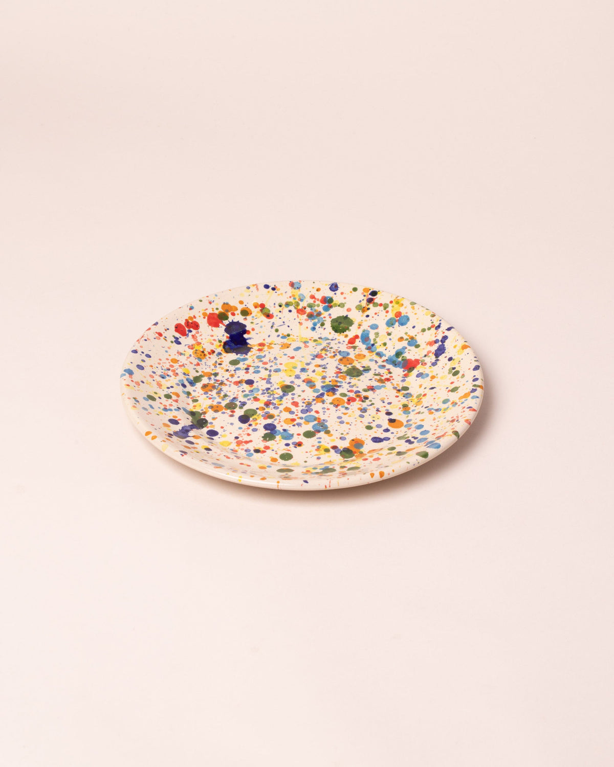 Closeup details of the La Ceramica Vincenzo Del Monaco Colored Drops Medium Dish on light color background.